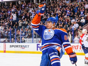EDMONTON, AB - NOVEMBER 21: Nail Yakupov #64 of the Edmonton Oilers celebrates after assisting the goal of Sam Gagner #89 (not pictured) against the Florida Panthers during an NHL game at Rexall Place on November 21, 2013 in Edmonton, Alberta, Canada.