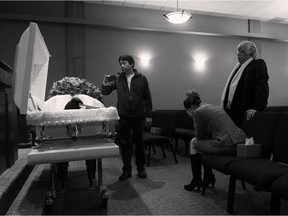 This photo of grieving friends at the viewing for slain Edmonton convenience store clerk Ricky Cenabre last December won Amber Bracken first place in the general news category from the News Photographers Association of Canada.