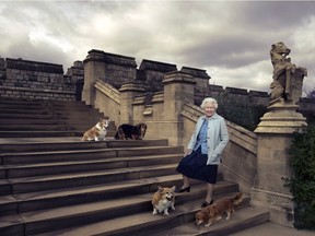 In this official photograph released by Buckingham Palace on April 20, 2016  to mark her 90th birthday, Queen Elizabeth II is seen walking in the private grounds of Windsor Castle, in England, on steps at the rear of the East Terrace and East Garden with four of her dogs: clockwise from top left Willow (corgi), Vulcan (dorgie), Candy (dorgie) and Holly (corgi).
