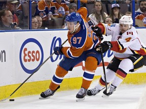 Edmonton Oilers' Connor McDavid, seen here being chased by Calgary's Kris Russell, will square off against his former childhood teammate, Flames forward Sam Bennett, on Saturday, April 2, 2016 at Rexall Place.