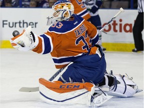 The Edmonton Oilers' goalie Cam Talbot (33) makes a glove save against the Vancouver Canucks during first period NHL action during the last NHL game at Rexall Place, in Edmonton Alta. on Wednesday April 6, 2016.