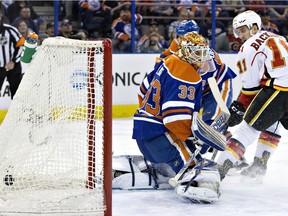 Calgary Flames' Mikael Backlund (11) scores a goal on Edmonton Oilers goalie Cam Talbot (33) during first period NHL action in Edmonton, Alta., on Saturday April 2, 2016.