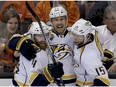 Nashville Predators center Colin Wilson, middle, celebrates with defenseman Ryan Ellis, left, and center Craig Smith after Wilson scored during the second period of Game 1 in an NHL hockey Stanley Cup playoffs first-round series against the Anaheim Ducks in Anaheim, Calif., Friday, April 15, 2016.