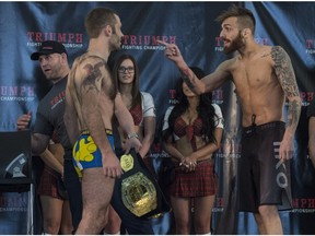 Andrew McInnes, right, gestures at Tom Gallicchio Thursday at West Edmonton Mall during the weigh-in for the Triumph Fighting Championship: Inception card. The fight is Friday at the Shaw Conference Centre.