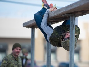 Canadian skeleton racer Mirela Rahneva gets hung up on the training obstacle course at the Canadian Forces Base in Wainright. The athletes are part of an exchange with the Canadian Armed Forces.