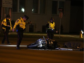 Police investigate a collision between a motorcycle and a street-cleaning vehicle on 104 Street and 58 Avenue in Edmonton on Monday, April 18, 2016.