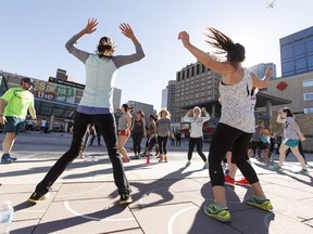 Participants exercise during Power Over Poverty's launch at Churchill Square in Edmonton on April 1, 2016.