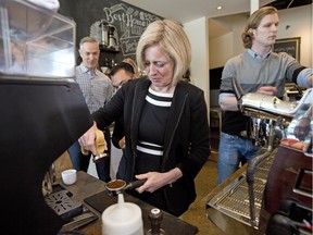 Alberta Premier Rachel Notley learns to make coffee on an espresso maker at Transcend, a small business, in Edmonton on April 15, 2016. The 2016 budget, released on day earlier,  announced that Alberta's small-business tax rate will be cut from three per cent to two per cent as of January 2017.