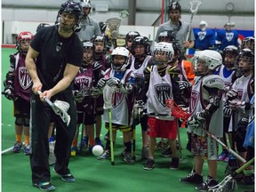 EDMONTON, AB. APRIL 2 , 2014 - Edmonton Rush's assistant coach Jimmy Quinlan, left, coaches kids at the Vimy Ridge spring lacrosse camp goalscoring techniques in Edmonton on Wednesday, April 2, 2014. The Vimy Ridge spring lacrosse camp runs for two days and is open for tykes to midgets levels.  ( Evan Buhler / Edmonton Journal )