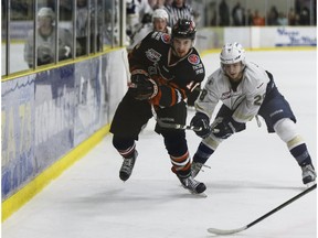 Spruce Grove's Nicolas Correale (right) battles Lloydminster's Zac Giroux during an AJHL playoff game between the Spruce Grove Saints and the Lloydminster Bobcats at Grant Fuhr Arena in Spruce Grove, Alta., on Friday April 1, 2016.