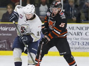 Spruce Grove's Brandon Biro (left) battles Lloydminster's Kris Spriggs during an AJHL playoff game between the Spruce Grove Saints and the Lloydminster Bobcats at Grant Fuhr Arena in Spruce Grove, Alta., on Friday April 1, 2016. Photo by Ian Kucerak