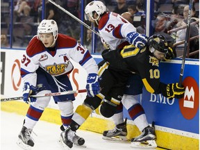 Edmonton's Brandon Baddock (13) and Dysin Mayo (37) battle Brandon's Kale Clague (10) during WHL playoff action at Rexall Place on April 3, 2016. The Wheat Kings won 5-2 to take a 3-2 series lead.