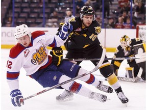 Edmonton's Dario Meyer (12) is taken down by Brandon's Kale Clague (10) during the third period of a WHL playoff game between the Edmonton Oil Kings and the Brandon Wheat Kings at Rexall Place in Edmonton, Alta., on Sunday April 3, 2016. Photo by Ian Kucerak