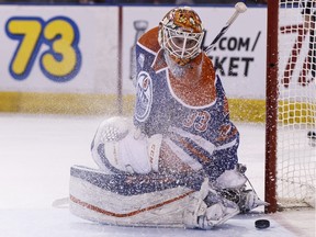 Edmonton's goaltender Cam Talbot (33) is scored on by Calgary's Joe Colborne (not shown) during the second period of a NHL game between the Edmonton Oilers and the Calgary Flames at Rexall Place in Edmonton on April 2, 2016.