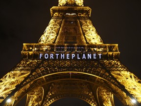 The slogan "FOR THE PLANET" is projected on the Eiffel Tower as part of the COP21, United Nations Climate Change Conference in Paris on Dec. 11, 2015. World leaders will be in New York on April 22, Earth Day, to finalize the agreement.