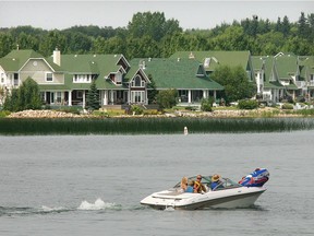 A pleasure boat cruises past the Marina Bay area on the shore of Sylvan Lake in this file photo.