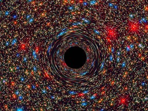 This computer-simulated image shows a supermassive black hole at the core of a galaxy. The black region in the centre represents the black hole's event horizon, where no light can escape the massive object's gravitational grip. The black hole's powerful gravity distorts space around it like a funhouse mirror. Light from background stars is stretched and smeared as the stars skim by the black hole.