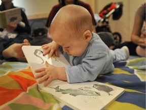 Babies and books belong together, says a letter writer, delighted to see a program that started 20 years ago is still up and running. In this 2011 file photo, a baby enjoys a story during Baby Laptime at the Stanley Milner Library.