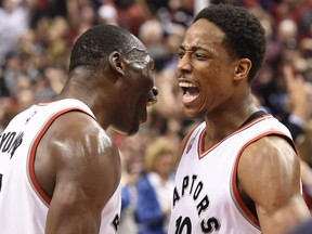 Toronto Raptors guard DeMar DeRozan (10) celebrates his team's victory over the Indiana Pacers with teammate Bismack Biyombo after NBA basketball playoff action in Toronto on Tuesday, April 26, 2016.