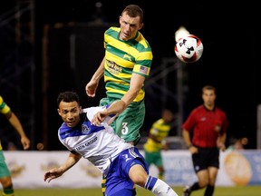 Tampa Bay Rowdies defender Neill Collins, right, heads a ball in front of FC Edmonton midfielder Cristian Raudales in a North America Soccer League match in Tampa, Florida on Saturday. Tampa Bay won 1-0.