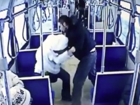 A screen shot from an  Edmonton Transit System video that was played for the jury at the second-degree murder trial of Jeremy Newborn, 32, and showed the accused repeatedly punching victim John Hollar, 29, as shocked passengers look on and move away.