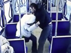 A screen shot from an  Edmonton Transit System video that was played for the jury at the second-degree murder trial of Jeremy Newborn, 32, and showed the accused repeatedly punching victim John Hollar, 29, as shocked passengers looked on and moved away.