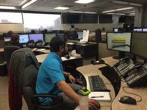 An operator works the phones Monday in the Edmonton Police Service 911 call centre.