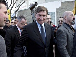 Wayne Gretzky meets with fans in front of his statue before NHL action between the Vancouver Canucks and Edmonton Oilers in Edmonton, Alta., on Wednesday April 6, 2016. It will be the Oilers' last game at the only arena they've ever known, dating back to the World hockey Association in the 1970s.
