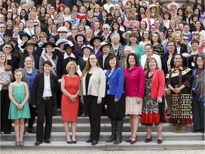 Women from all walks of life, including Premier Rachel Notley, pose Tuesday for a photo on the steps of the Alberta legislature to commemorate the 100-year anniversay of the equal suffrage law that gave most women the right to vote.