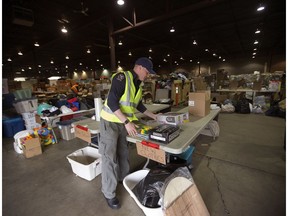 Patrick Bradley sorts donations at the Edmonton Emergency Relief Services Society (EERSS) Donation Warehouse.