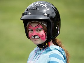 Ashley Bos, 10, waits for a ride on a motorcycle during the Kids with Cancer Parade of Heroes (Motorcycle Adventure) at Hawrelak Park, in Edmonton Alta. on Saturday May 28, 2016. Photo by David Bloom