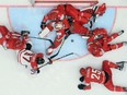 Canada's forward Connor McDavid (2nd L) attacks the net of Belarus' goalie Kevin Lalande during the group B preliminary round game Belarus vs Canada at the 2016 IIHF Ice Hockey World Championship in St. Petersburg on May 9, 2016. / AFP PHOTO / ALEXANDER NEMENOVALEXANDER NEMENOV/AFP/Getty Images