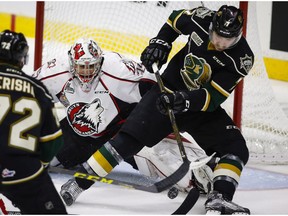 Rouyn-Noranda Huskies goalie Chase Marchan, left, looks on as London Knights' Matthew Tkachuk tries for a rebound during second period CHL Memorial Cup hockey action in Red Deer, Tuesday, May 24, 2016.THE CANADIAN PRESS/Jeff McIntosh ORG XMIT: JMC110