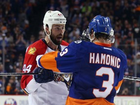 NEW YORK, NEW YORK - APRIL 17: Erik Gudbranson #44 of the Florida Panthers talks with Travis Hamonic #3 of the New York Islanders during the second period during Game Three of the Eastern Conference Quarterfinals during the 2015 NHL Stanley Cup Playoffs at the Barclays Center on April 17, 2016 in the Brooklyn borough of New York City.  (Photo by Bruce Bennett/Getty Images) ORG XMIT: 629092197