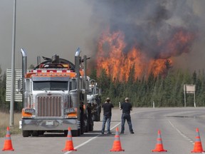 A giant fireball is seen as a wild fire rips through the forest 16 km south of Fort McMurray, Alberta on Highway 63 on May 7, 2016.