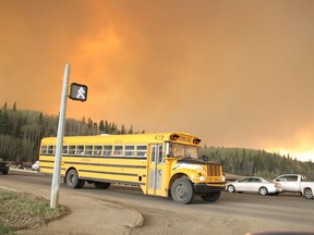 A school bus evacuating children from a school in the subdivision of Abasand waits a stoplight in Fort McMurray, Alta., last week.