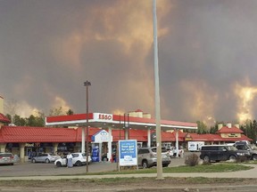 A wall of fire rages outside of Fort McMurray, Tuesday May 3.