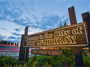 A Welcome to Fort McMurray sign stands on the side of Highway 63 on the south end of Fort McMurray, Alta. on June 19, 2013.