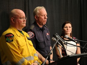 Alberta Forestry spokesman Bernie Schmitte (left), Fire Chief Darby Allen and Mayor Melissa Blake address the wildfires in Fort McMurray on May 2, 2016.