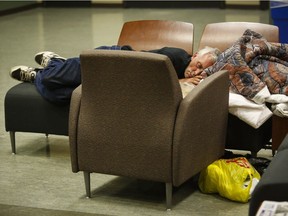 An evacuee from the Fort McMurray wildfires sleeps on chairs at the evacuation centre in Lac la Biche, Alta., Thursday, May 5, 2016.
