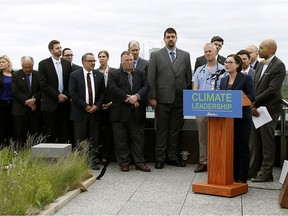 Alberta Environment Minister Shannon Phillips (at podium) introduced Bill 20, the Climate Leadership Implementation Act, on the roof of Edmonton's Federal building on May 24, 2016.
