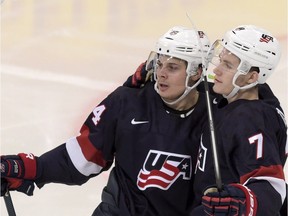 Auston Matthews, left, and Matthew Tkachuk of the U.S celebrate a goal during the 2016 IIHF World Junior Ice Hockey Championship bronze medal game between Sweden and the USA in Helsinki, Finland, Tuesday, Jan. 5, 2016. (Markku Ulander/Lehtikuva via AP)    FINLAND OUT. NO THIRD PARTY SALES.