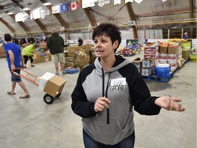 Gina Graham, above, her sister Tracey Keep, and 150 volunteers set up a rest area in Millview Recreation Complex in Boyle, Alta., where fire evacuees can pick up food, clothing and personal care products.