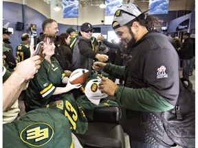 Edmonton Eskimos' Calvin McCarty signs autographs for fans after returning with the Grey Cup to Edmonton, Alta., on Monday November 30, 2015. The Eskimos defeated the Ottawa Redblacks 26-20 to win the 103rd Grey Cup in Winnipeg.