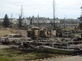 A burned out car and the remains of a house are seen in the Beacon Hill neighbourhood during a media tour of the fire-damaged city of Fort McMurray on May 9, 2016. McMurrayite Don Scott writes he is confident his city will recover from this disaster based on the strength of its people.