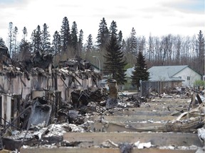 Homes destroyed by fire sit near untouched homes in the Abasand neighbourhood of Fort McMurray.