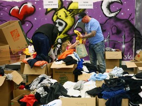 Fire evacuees sift through donated clothing at an Emergency Relief Centre in Edmonton, Alberta on May 10, 2016.