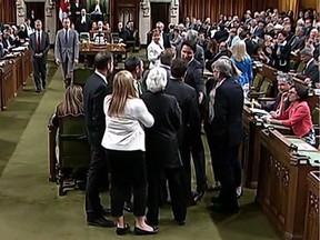 Footage from the House of Commons television feed shows Prime Minister Justin Trudeau wading into a clutch of MPs, mostly New Democrats, and pulling Opposition whip Gordon Brown through the crowd in order to get a vote started on the assisted-dying bill Wednesday May 18, 2016.