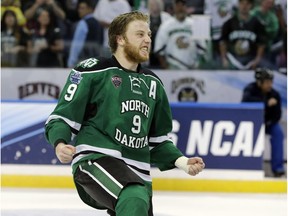 North Dakota forward Drake Caggiula (9) celebrates the team's 5-1 over Quinnipiac during an NCAA Frozen Four championship college hockey game Saturday, April 9, 2016, in Tampa, Fla.