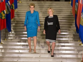 Alberta Premier Rachel Notley and Ontario Premier Kathleen Wynne walk down to meet the media during Wynne's visit to Edmonton on May,  26 2016.